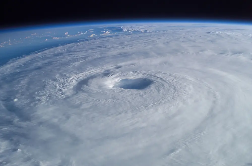 Hurricane Isabel photographed from orbit: a vast white spiral of cloud with a clear dark eye at its centre.