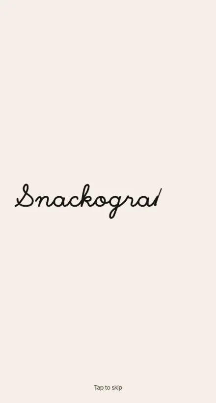 The Snackography title screen. The wordmark draws itself in a single handwritten line on a cream screen.